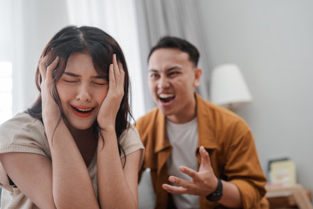A couple is arguing, clearly showing their distress and frustration during the confrontationの写真素材