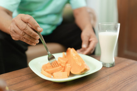 Enjoy fresh, sweet papaya slices with milk for a nutritious breakfast packed with vitaminsの写真素材