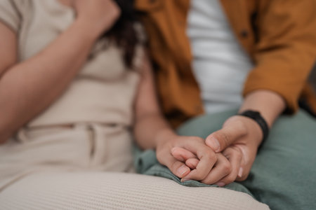 A closeup of a couples hands intertwined, showcasing their deep love and connectionの写真素材