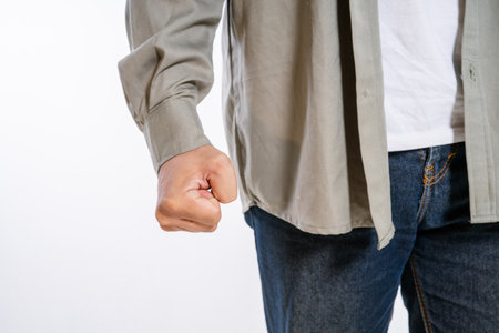 A mans clenched fist symbolizes strong emotions like anger or determination in contextの写真素材