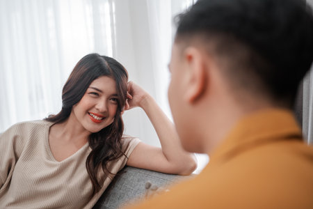 Two close friends have a warm conversation, sharing genuine smiles and heartfelt laughterの写真素材