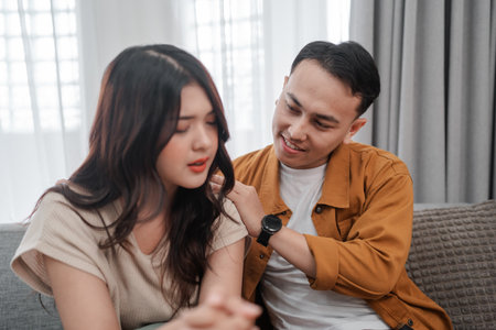 A couple shares a warm moment of deep emotional connection and mutual support at homeの写真素材