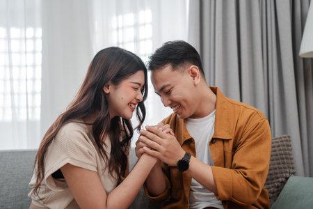 A loving couple enjoying a tender and intimate moment with each other in a cozy indoor settingの写真素材