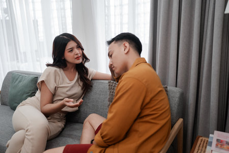 A couple is engaged in a meaningful conversation in a stylishly decorated living roomの写真素材