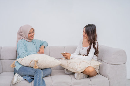 Friends share a joyful moment on a stylish couch, showcasing the essence of true friendshipの写真素材