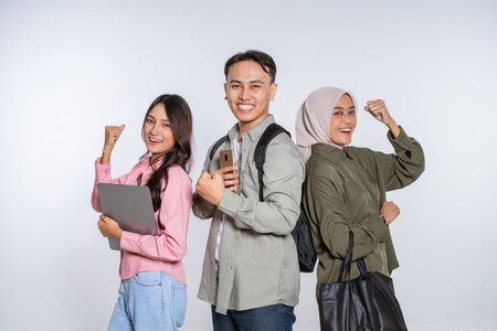 A group of young adults is celebrating their significant academic achievements with joyの写真素材