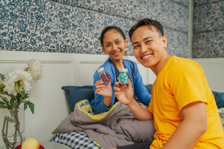A cheerful mother and son enjoy snacks together in a beautiful home environment.の写真素材