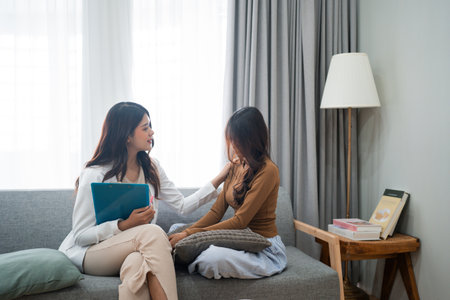 A therapy session that showcases deep empathy and support between two women, fostering healingの写真素材