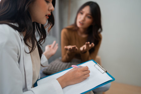 A therapist listens intently to their client during a deeply engaging counseling sessionの写真素材