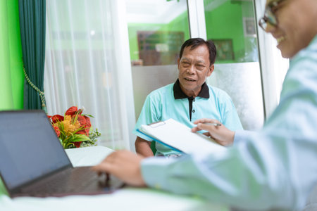 A healthcare provider is currently discussing treatment options with an elderly patient in detail