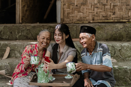 A heartwarming scene of family bonding over tea in a serene, rustic environment.の写真素材