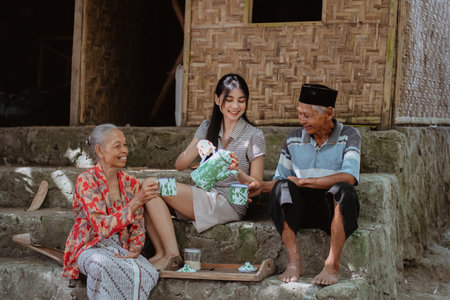 A family gathering enjoying delightful tea together in a tranquil outdoor settingの写真素材