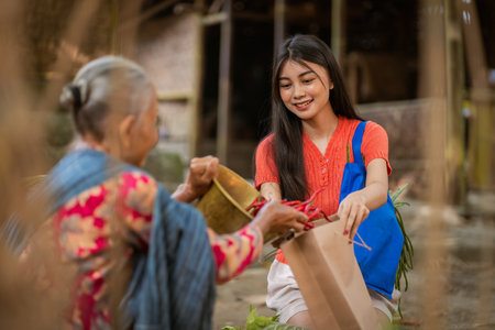 A vibrant scene of a young woman sharing with an elderly neighbor, showcasing community spirit and connection.の写真素材