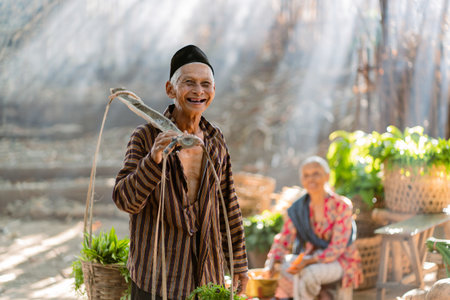 A joyful and cheerful elderly man dressed in traditional attire holds a woven basket in a lively vibrant outdoor marketの写真素材