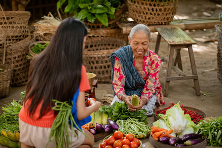 A bustling market scene showcasing fresh vegetables and a cultural exchange between generations of peopleの写真素材