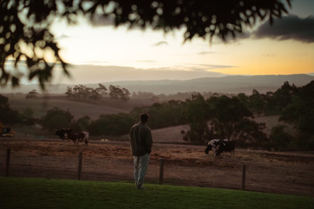 Enjoy a serene moment watching the sunset on a peaceful rural farm, surrounded by nature