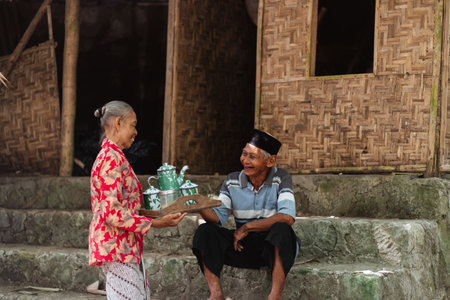 Experiencing and enjoying a traditional tea service in a serene and rustic village environmentの写真素材