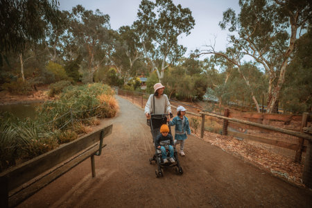 A lovely family walk in a beautiful park, surrounded by vibrant nature while enjoying quality time togetherの写真素材