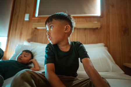 Two boys are enjoying themselves in a warm, cozy, and inviting settingの写真素材