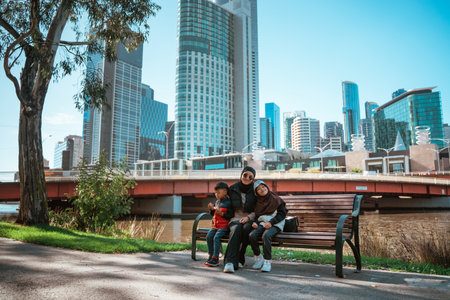 A happy family enjoys quality time together in a vibrant park, making memoriesの写真素材