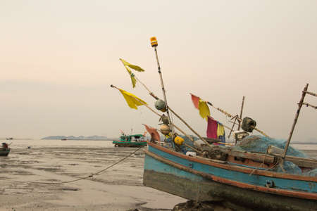 A boat on the mud when   the low water times.の写真素材