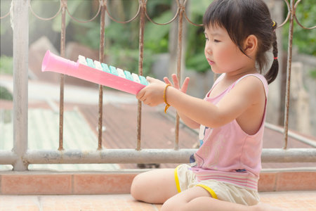 Asian girl playing on the garden.の写真素材