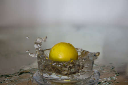 Lemon drop in water splash.の写真素材