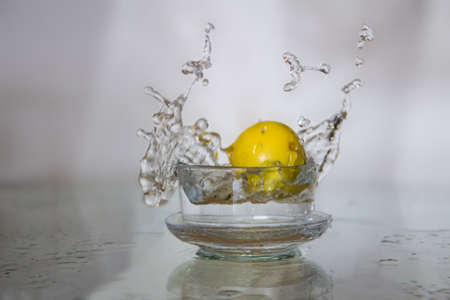 Lemon drop in water splash.の写真素材