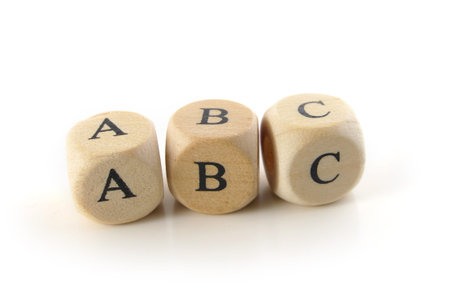 abc, spelled with wooden alphabet blocks, education toy to learn reading and writing, isolated on...