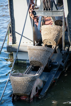 historical excavator bucket in the habor of Luebeckの写真素材