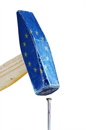 hammer with flag of the european union hitting a rusty nail, conceptual metaphor of pressure in the euro crisis, isolated on white backgroundの写真素材