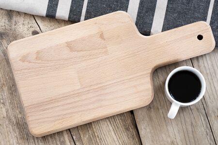 blank breakfast board and coffee cup on a vintage table, view from above, food background with copy spaceの写真素材