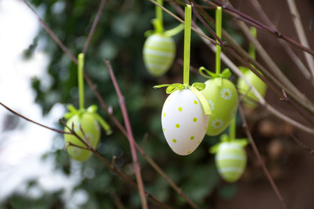 easter decoration, green patterned eggs hanging in bare branches