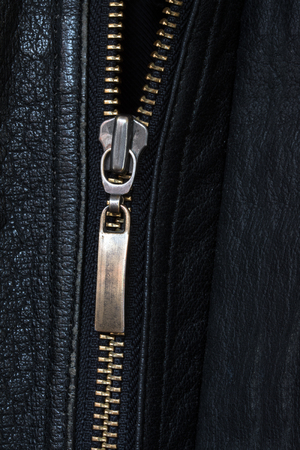 metallic zipper in black leather, upright background with copy spaceの写真素材