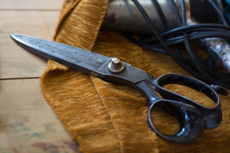 old tailor scissors in the shop floor of a upholstery manufactory, narrow depth of fieldの写真素材
