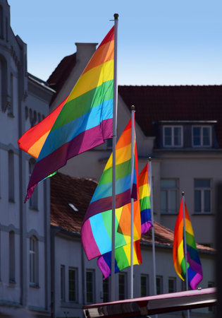 Glowing rainbow flags in the shady Old Town of Luebeck, symbol of tolerance and acceptance, diversity, hope and longing. The colors of this flag are specially for LGBT (Lesbian, Gay, Bisexual, Transgender) Prideのeditorial素材