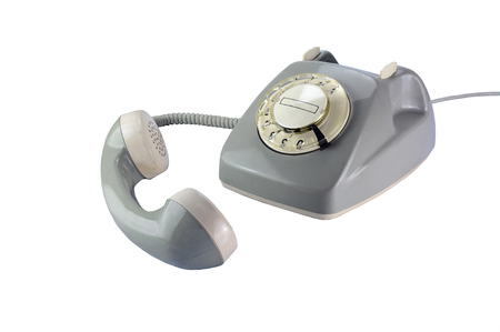 Vintage rotary dial phone in gray with removed telephone receiver isolated on a white backgroundの写真素材