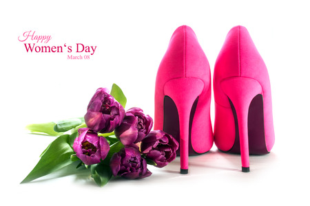 Ladies pink high heel shoes from behind and tulips isolated with shadows on a white background, concept symbol for love, sample text Happy Women's Day March 08, selected focusの写真素材