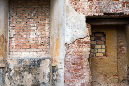 different structures and textures of brick masonry and plaster in a ruin, lost place background with copy spaceの写真素材