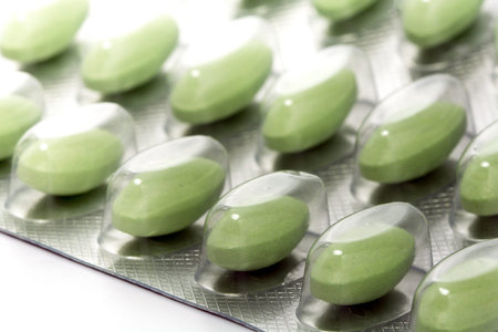 green pills in a blister pack, closeup with selected focus, narrow depth of fieldの写真素材