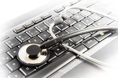 Data protection, stethoscope on a business computer keyboard, concept of antivirus repair service or password theft, selected focus, narrow depth of fieldの写真素材