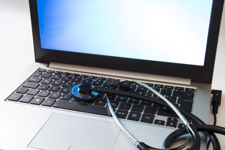 Computer protection, stethoscope on the keyboard of a business office laptop, antivirus repair...