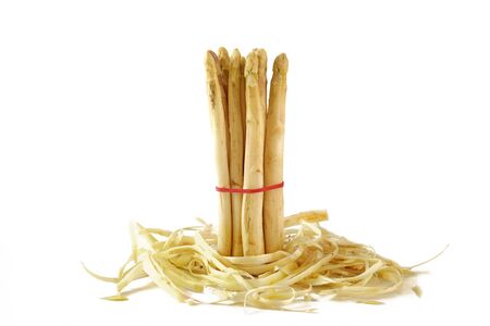 bunch of white asparagus, fresh and organic standing in asparagus peel, isolated on a white backgroundの写真素材