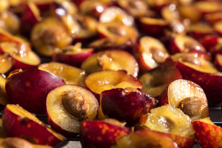 Sliced red plums for the cake , food or baking background, closeup with selective focus, narrow depth of fieldの写真素材