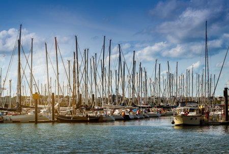 sailing yacht harbor with many sailboats in the evening light against a blue sky with clouds in Cuxhaven, Germanyのeditorial素材