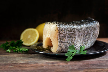 raw northern pike, piece of the fresh fish cleaned and prepared for cooking on a rustic wooden table, dark background with copy space, selected focus, narrow depth of fieldの写真素材