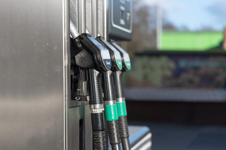 fuel pump filling nozzles for petrol and diesel at a gasoline station, copy space, selected focus
