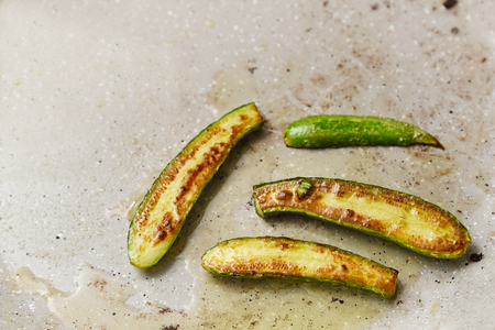 baked mini zucchini on a grey baking tray with copy space, mediterranean vegetable recipe, high angle view from above, selected focus, narrow depth of fieldの写真素材