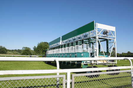 start gate trailer for the horse race on a green grass track at a sunny day against the blue sky, copy space, selected focusのeditorial素材
