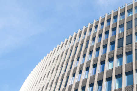 detail of the Office and commerce building Spreedreieck at Friedrichstrasse No. 140 in Berlin, Mitte district, germany, by the architect Marc Braun, blue sky with copy spaceのeditorial素材